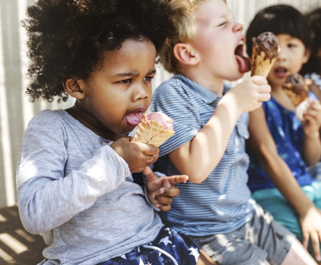 Kids enjoying ice cream treats on a sunny day, representing the Wahnapitei First Nation community