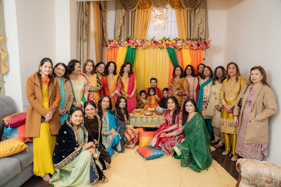 A lively family gathering indoors with vibrant traditional attire and decorations in Brampton, Canada.