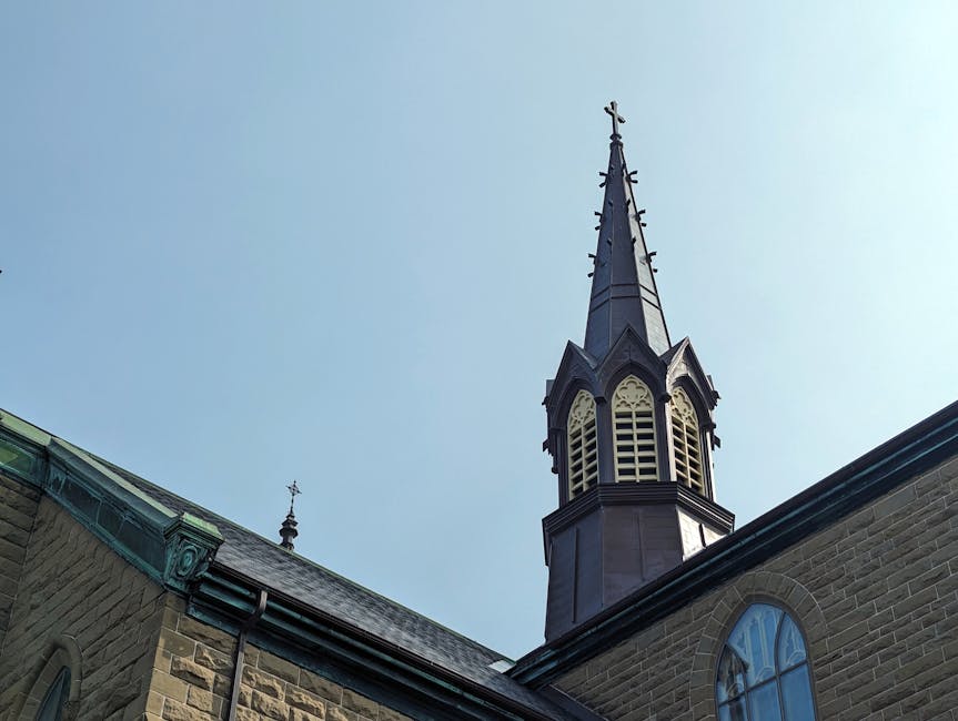 Close-up view of a historic church tower in Charlottetown, PEI, Canada on a clear day.