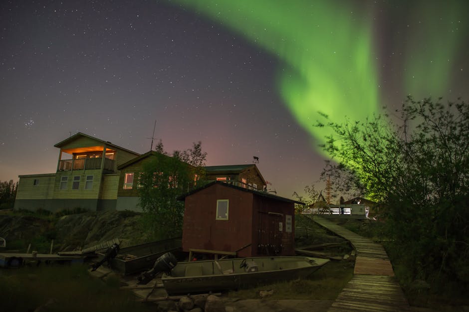 A stunning view of the aurora borealis illuminating the night sky over a house in Yellowknife, Canada.