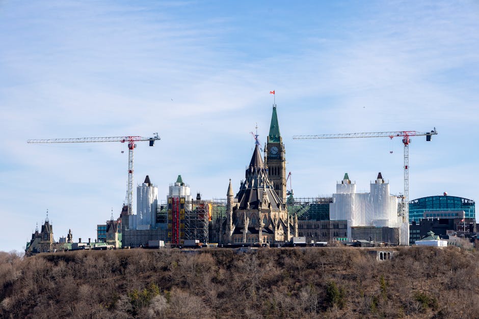 A view of construction cranes around the iconic Ottawa Parliament building under renovation.
