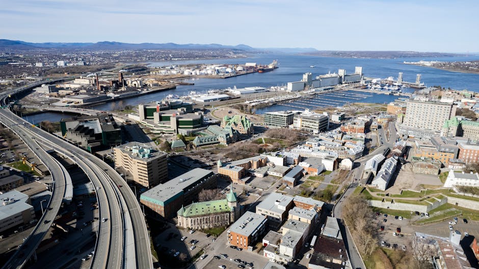Stunning aerial shot of Québec City skyline with the St. Lawrence River and bustling harbor in view.