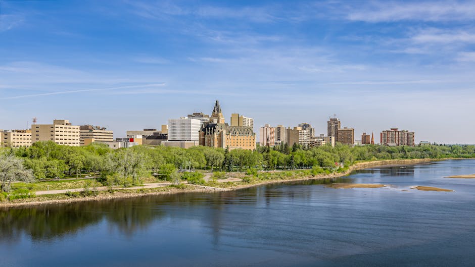 A beautiful spring view of Saskatoon cityscape with a river and reflections.