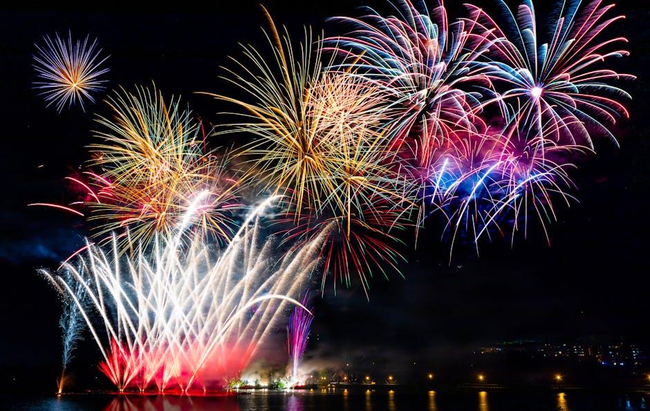 Spectacular fireworks light up the night sky over a calm Sherbrooke lake, celebrating a festive occasion.