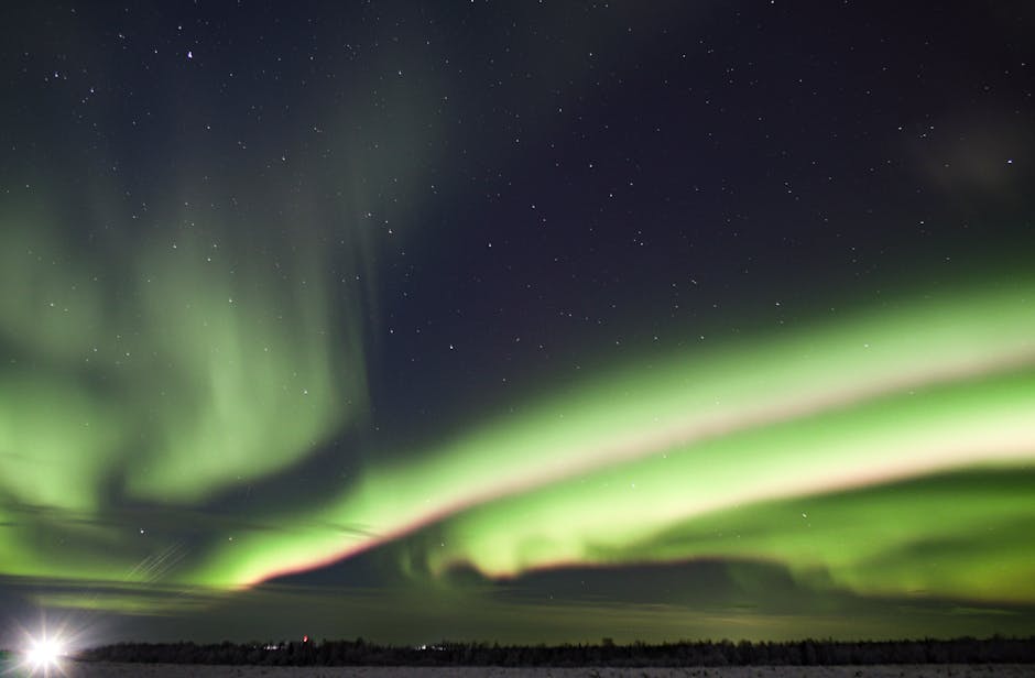 Captivating view of aurora borealis dancing across a starry night sky.