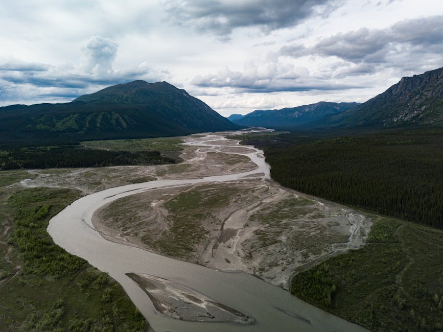 Stunning aerial photo showcasing the winding river and mountainous terrain of Yukon, Canada.